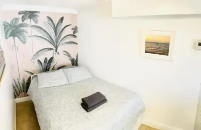 a bedroom with a bed with a purse on it at The Blue Breeze - Parking included in Miami Beach