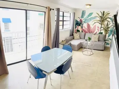 a living room with a table and chairs at The Blue Breeze - Parking included in Miami Beach