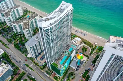 an aerial view of a tall building next to the ocean at Luxurious Beachfront 2-Bedroom 2-Bathroom with balcony Condo at Lyft Resort & Residences - Miami Beach in Hollywood