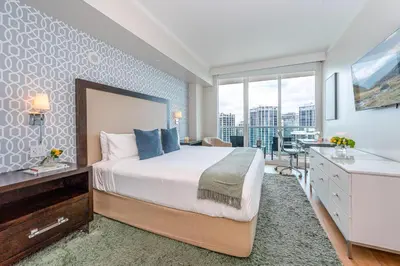 a bedroom with a bed and a desk and a window at Coconut Grove Bayview Retreat 2 King Suites Pool Gym and Free Parking in Miami