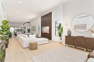 a living room with a white couch and a mirror at Luxury Miami Oasis with Heated Pool and BBQ Grill in Miami