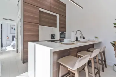 a kitchen with a large island with stools at Luxury Miami Oasis with Heated Pool and BBQ Grill in Miami
