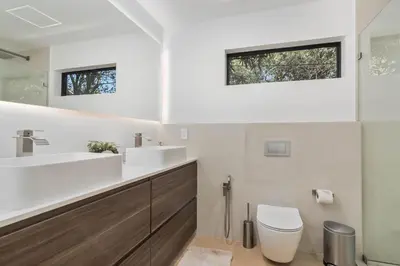 a bathroom with a sink and a toilet and a window at Luxury Miami Oasis with Heated Pool and BBQ Grill in Miami