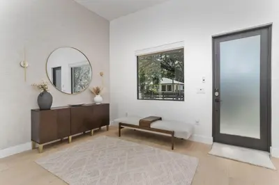a living room with a mirror and a table at Luxury Miami Oasis with Heated Pool and BBQ Grill in Miami