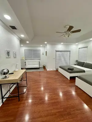 a large living room with a bed and a table at Luxury 5BR Villa Private Pool I Jacuzzi I BBQ I Piano I Near Miami Airport in Kendale Lakes