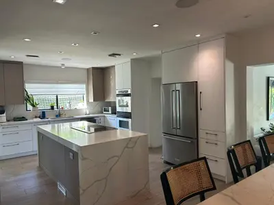 a kitchen with a refrigerator and a table and chairs at Luxury Miami home with heated pool & BBQ area, close to beaches & sports arenas in Miami