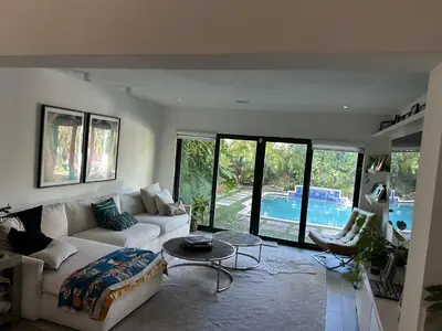 a living room with a white couch and a table at Luxury Miami home with heated pool & BBQ area, close to beaches & sports arenas in Miami