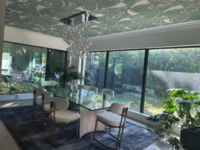 a dining room with a glass table and chairs at Luxury Miami home with heated pool & BBQ area, close to beaches & sports arenas in Miami