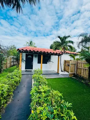 a house with a gate and a walkway at Modern Boho 3BR Duplex Escape with Pool & King Bed Near Beach in Fort Lauderdale