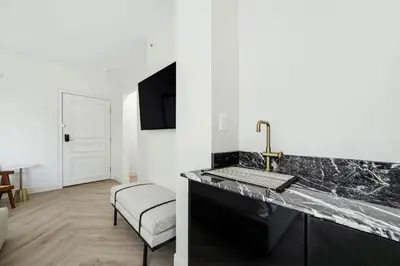 a kitchen with a sink and a chair in a room at The Lemon Branch Hotel in Miami Beach
