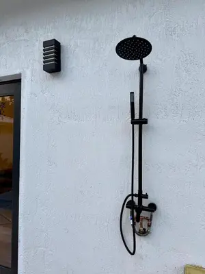 a black shower head on the side of a wall at Oasis Yard -Pool-Jets-Game Room-BBQ-Relaxing in Carver Ranches
