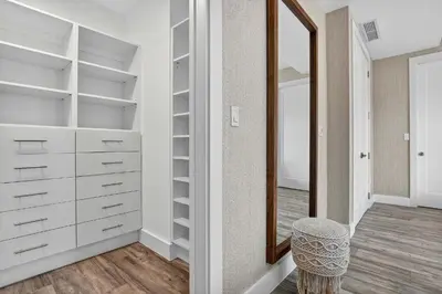 a walk in closet with a mirror and a stool at Shoreline Villa by Rove - Rooftop & Beach Access in Hollywood