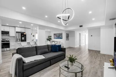 a living room with a couch and a kitchen at Contemporary Family Oasis Pool and Comfort in Miami