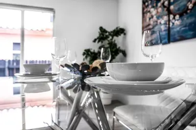 a dining room table with two glasses and a tableablish at Contemporary Family Oasis Pool and Comfort in Miami