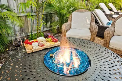 a fire pit on a table with a tray of food at 2 bed, steps from Wilton Drive, BBQ, fire pit in Fort Lauderdale