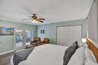 a bedroom with a bed and a ceiling fan at Waterfront, Heated Pool, Game Room in Fort Lauderdale