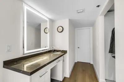 a bathroom with a sink and a mirror at Seaview Work Haven Condo for 6 in Miami