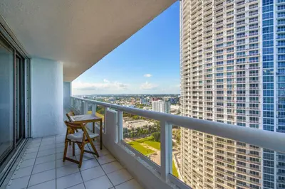 a balcony with a desk and a view of a city at Seaview Work Haven Condo for 6 in Miami