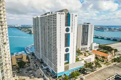 an aerial view of a tall white building next to the water at Seaview Work Haven Condo for 6 in Miami