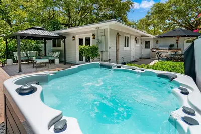 a swimming pool in front of a house at Beach Oasis Heated Pool, Gazebo, Hot Tub in Fort Lauderdale