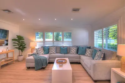 a living room with a couch and a table at Beach Oasis Heated Pool, Gazebo, Hot Tub in Fort Lauderdale