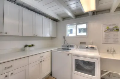 a kitchen with white cabinets and a dishwasher at Beach Oasis Heated Pool, Gazebo, Hot Tub in Fort Lauderdale