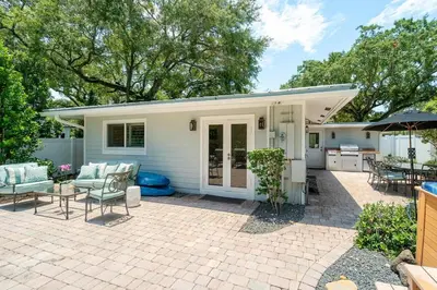 a house with a patio with a table and chairs at Beach Oasis Heated Pool, Gazebo, Hot Tub in Fort Lauderdale