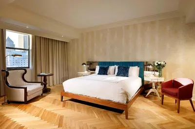 a bedroom with a large bed and a chair at Eurostars Langford in Miami