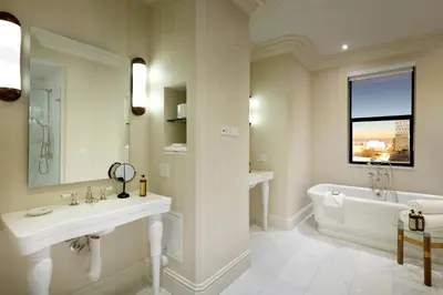 a white bathroom with a tub and a sink and a bath tub at Eurostars Langford in Miami