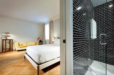 a bedroom with a bed and a glass shower at Eurostars Langford in Miami