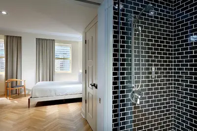 a bathroom with a black tile wall and a shower at Eurostars Langford in Miami