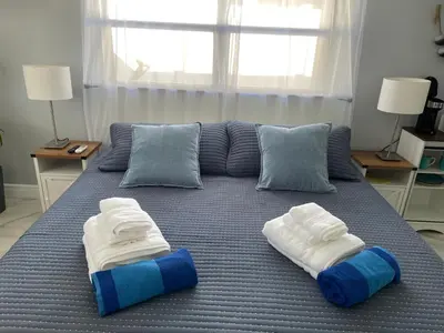 a bed with blue and white towels on it at Aquaria in Fort Lauderdale