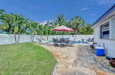 a patio with a table and chairs and an umbrella at Aquaria in Fort Lauderdale