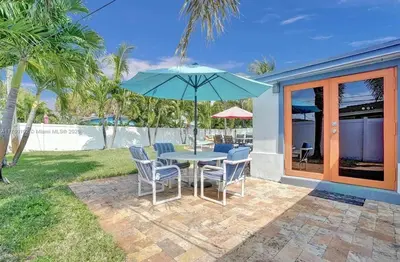 a patio with a table and chairs and an umbrella at Aquaria in Fort Lauderdale