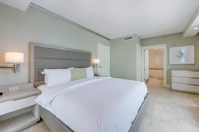 a bedroom with a large white bed in a room at Oceanfront Retreat- South Beach Pool Amenities in Miami Beach