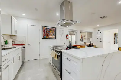 a white kitchen with a sink and a stove at JS & JS 2040 LLC in Fort Lauderdale