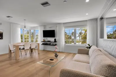 a living room with a couch and a table at Peaceful 2BR Condo with Ocean Views on Ocean Drive South Beach in Miami Beach