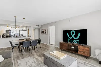 a living room with a host sign on the wall at Stylish Brickell Stay with Ocean Views & Pool in Miami