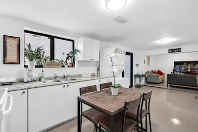 a kitchen and dining room with a table and chairs at Buena Vista vacation home with privacy and close to everything in Miami