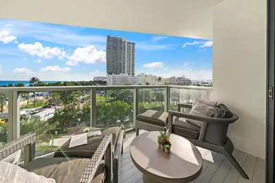 a balcony with a table and chairs and a view of the city at OceanView 1B Private Residence at South Beach - 514 in Miami Beach