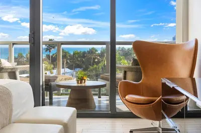 a living room with a chair and a table at OceanView 1B Private Residence at South Beach - 514 in Miami Beach