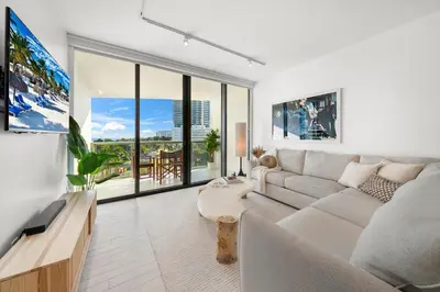 a living room with a couch and a tv at OceanView 1B Private Residence at South Beach - 514 in Miami Beach