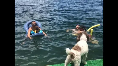 a man and a woman and a dog in the water at Serene Lakefront Getaway Fishing & Kayaks in Fort Lauderdale