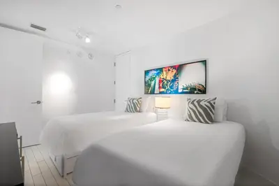 two beds in a room with white walls at OceanView 1B Private Residence at South Beach - 1114 in Miami Beach