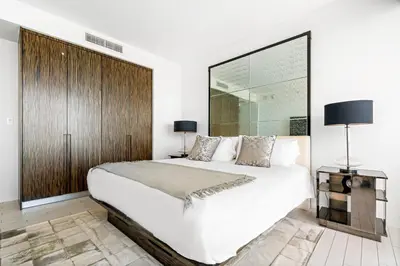 a bedroom with a large white bed and a wooden wall at OceanView 1B Private Residence at South Beach - 1114 in Miami Beach