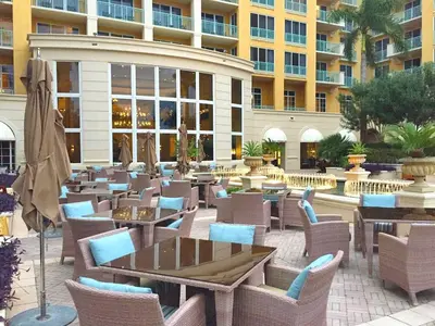 a restaurant with tables and chairs in front of a building at Modern Miami Suite Near the Beach in Miami