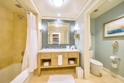 a bathroom with a sink and a tub and a toilet at Modern Miami Suite Near the Beach in Miami