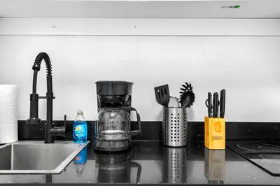a kitchen counter with a coffee maker and utensils at Modern Studio in Wynwood Midtown in Miami