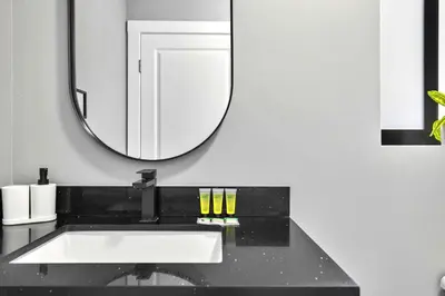 a bathroom with a sink and a mirror at Modern Studio in Wynwood Midtown in Miami
