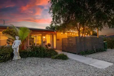 a small house with a statue in front of it at Wilton Manors Twin Oasis | 2 Heated Pools, For 12 in Fort Lauderdale